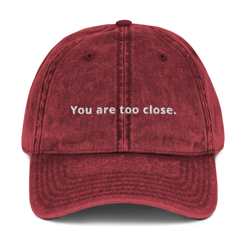 Produktbild der bestickten Vintage-Cap 'You are too close' auf weißem Hintergrund. Ein humorvolles Accessoire für Menschen, die ihren persönlichen Raum schätzen.